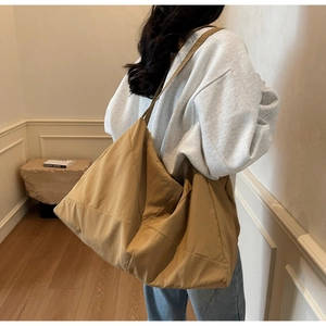 Close-up of lightweight khaki tote bag showing spacious design and durable shoulder strap