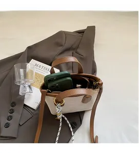 Interior view of white embossed bucket bag showing capacity for two smartphones