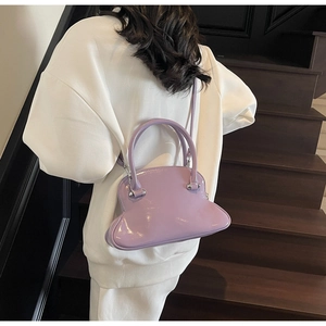 Close-up of a modern light purple patent leather handbag with a unique bulbous shape