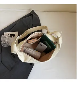 Detail view of large cream tote bag interior with umbrella and wallet capacity