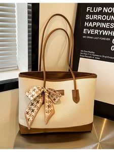 Large beige woven tote bag with brown leather trim and houndscallop silk bow detail