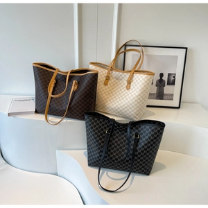 Detailed display of three patterned tote bags in brown, beige, and black colors