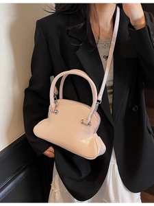 Chic pink glossy leather shell bag with top handles and adjustable shoulder strap