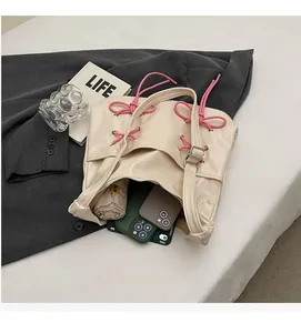 Detail of cream tote bag interior showing capacity for umbrella and smartphones