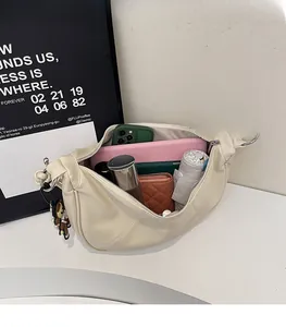 Interior view showing the large storage capacity of this cream crescent crossbody bag