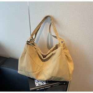 Close-up of khaki tote bag featuring unique stitched texture and minimalist nylon fabric
