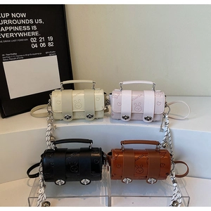 Detail of colorful mini cylinder bags with rabbit embossing and silver twist locks
