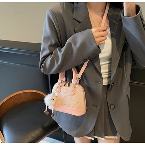 Light pink mini shell bag with cute puppy prints and a white fuzzy pompom charm