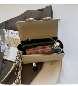 Interior view showing the large capacity of the cream pillow bag for phone and wallet
