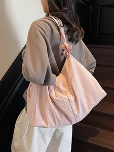 Pink quilted nylon tote bag with large capacity and stylish shoulder knot detail