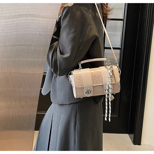 Detail of a beige PU leather crossbody bag featuring embossed rabbit and heart patterns