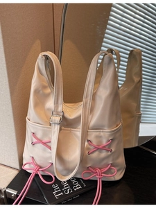 Off-white large capacity hobo bag with pink bow drawstring and metallic eyelets