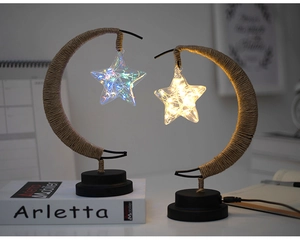 Artistic moon lamp with star-shaped bulb and brown hemp rope weaving on white desk