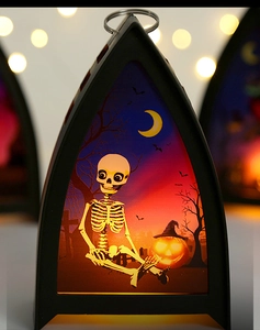 Halloween lantern detail featuring spooky skeleton and pumpkin illustration with warm LED glow