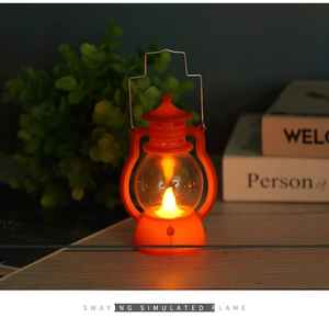 Close-up of bright orange retro Halloween lantern with warm LED flickering flame effect