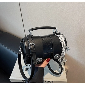 Detail of black cylinder pillow bag featuring embossed rabbit head and silver twist lock