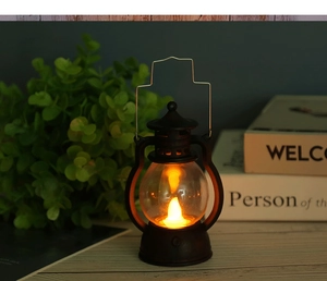 Macro view of vintage black LED lantern with warm flickering flame in a cozy setting