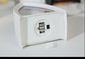 Detail of the white decorative LED lantern base showing battery compartment and power switch