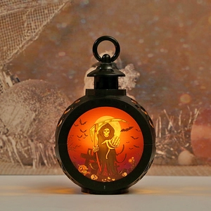 Halloween pumpkin lantern with matte black shell featuring reaper and graveyard scenes