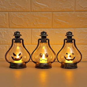 Close-up of three vintage bronze Halloween pumpkin lanterns with warm glowing LED lights