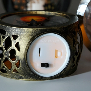 Detail view of the Halloween pumpkin lantern base with battery compartment and power switch