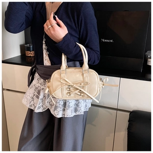 Détail du sac Boston beige avec nœud papillon et détails de laçage en cuir élégant