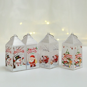 Close-up of four transparent Christmas lanterns with festive Santa and snowman prints