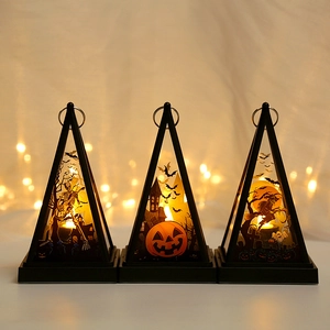 Three Halloween lanterns with skull and pumpkin silhouettes glowing in warm orange light