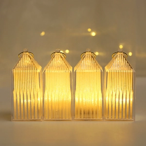 Set of four warm LED crystal house lanterns with golden hanging loops for Christmas