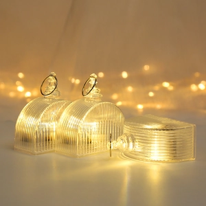 Close-up of three LED hanging crystal lights with warm yellow glow and vertical textures
