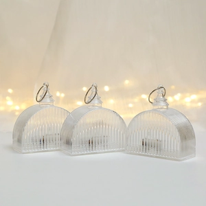 Close-up of three transparent LED crystal lights with vertical stripes and silver rings