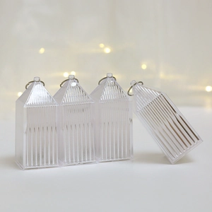 Detail view of transparent Christmas lantern cases showing metal needles inside