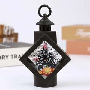 Detail of Halloween decorative lantern featuring black frame and pumpkin castle illustration
