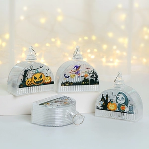 Detail view of hanging Halloween lanterns featuring spooky patterns and warm LED lights