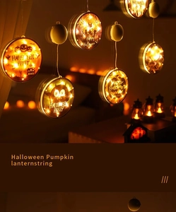 Detail view of glowing Halloween pumpkin and black cat LED hanging string lights