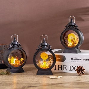 Three vintage Halloween LED lanterns with intricate spooky cutouts and warm glow