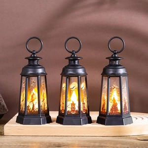 Set of three Halloween LED pumpkin lanterns with vintage graphics and warm yellow glow