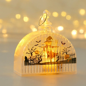 Detail of Halloween lantern with scarecrow and skull prints and warm LED glow