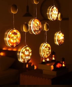 Close-up of LED Halloween window light with suction cup showing spooky festive graphics