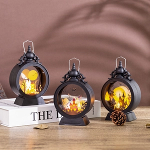 Three vintage Halloween LED lanterns with pumpkin and castle silhouettes on wood