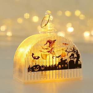 Detail of Halloween LED lantern with witch illustration and warm glowing light effect