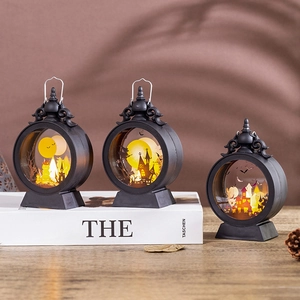 Detailed close-up of three decorative Halloween lanterns featuring spooky silhouettes