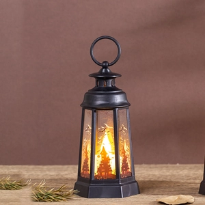 Detail of black Halloween lantern featuring orange light and castle bat patterns
