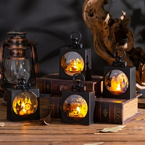 Close-up of Halloween LED lanterns with pumpkin and bat patterns in a dark setting