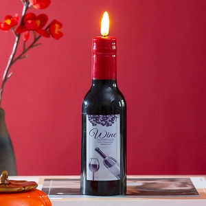 Close-up of LED wine bottle candle with realistic flame on decorative red background