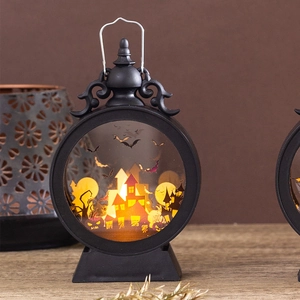 Close-up of vintage Halloween pumpkin lantern with warm LED light and spooky silhouettes