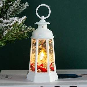 White Christmas lantern with Santa graphics and warm LED light on a snowy backdrop
