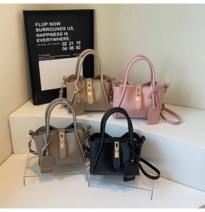 Litchi pattern bucket bags in four colors with gold metal buckles and adjustable straps