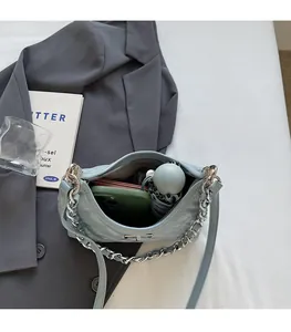 Top view of open blue quilted bucket bag showing space for phone and wallet