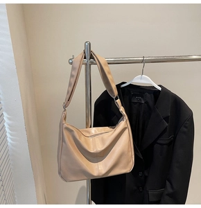 Detail of apricot large capacity hobo bag with wide adjustable strap and soft leather folds